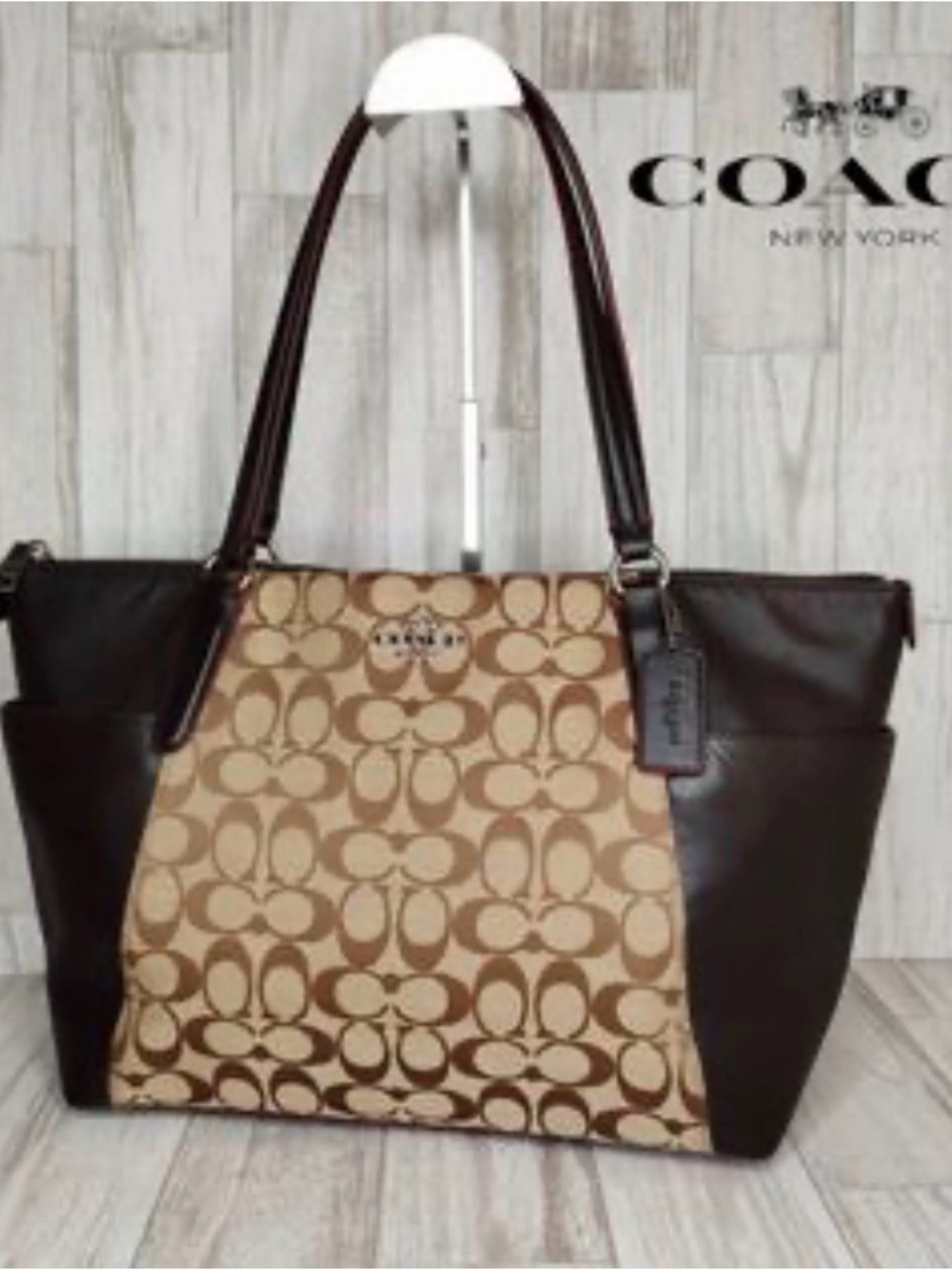 This is a Coach Ava Tote in Signature Canvas and dark brown leather trim.